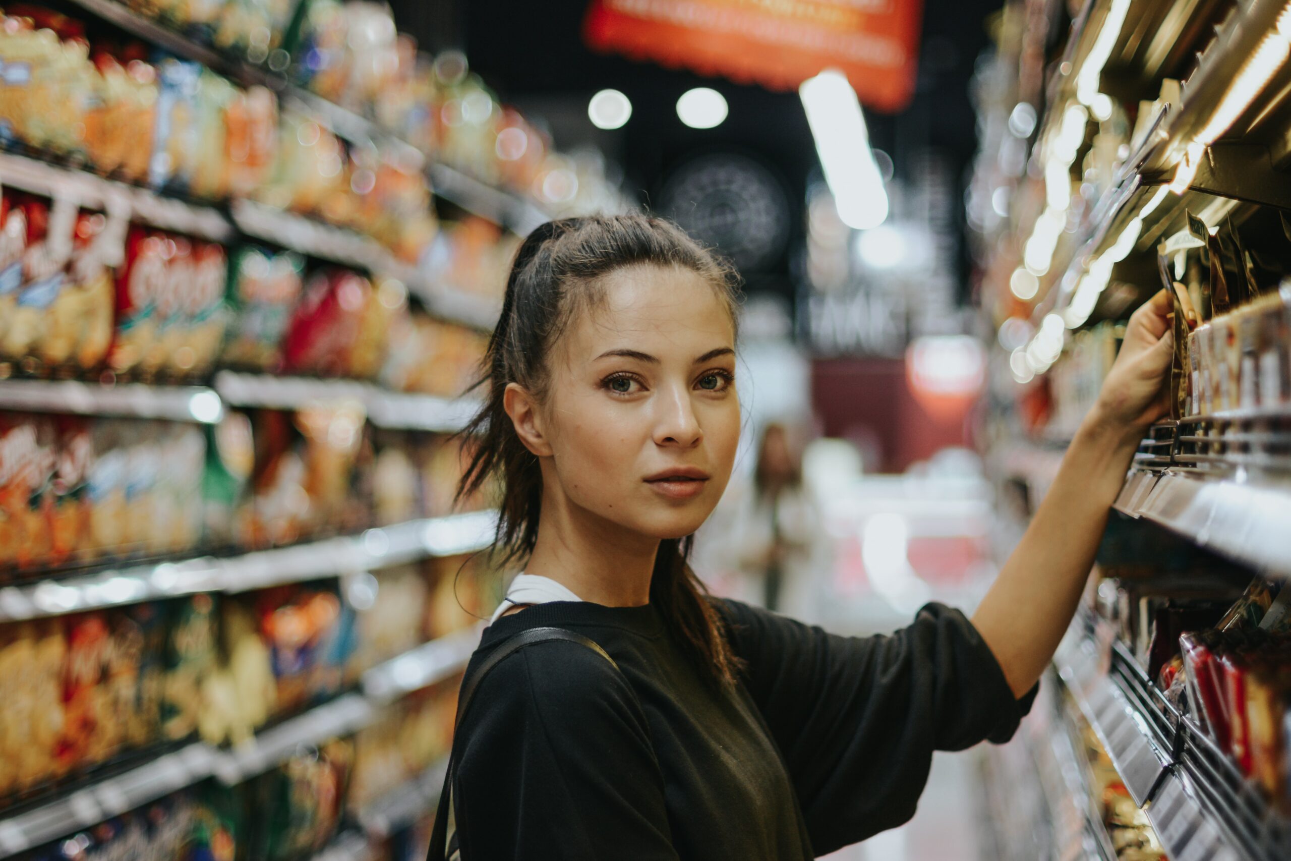 woman in grocery store choosing product